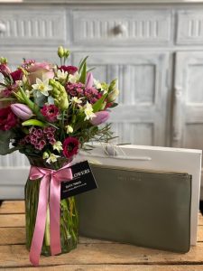 Small beautiful vase arrangement with a Katie Loxton wristlet pouch bag